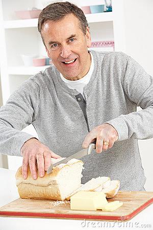 man slicing bread