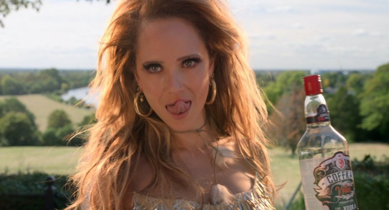 Keeley with a bottle of vodka, dressed for photo shoot