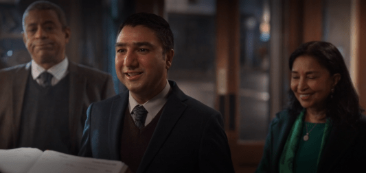 Three people standing, waiting for a table