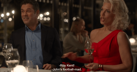 John and Rebecca at a dinner table with glasses of wine